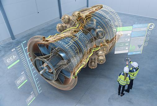 Two factory workers wearing augmented reality goggles working on a large motor