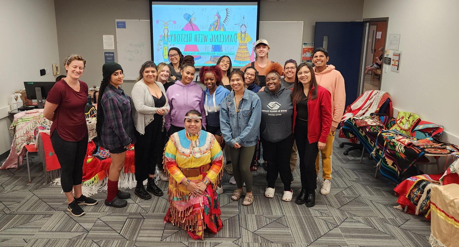 Group of Students pose for a photo at an Indigenous Dance educational event.