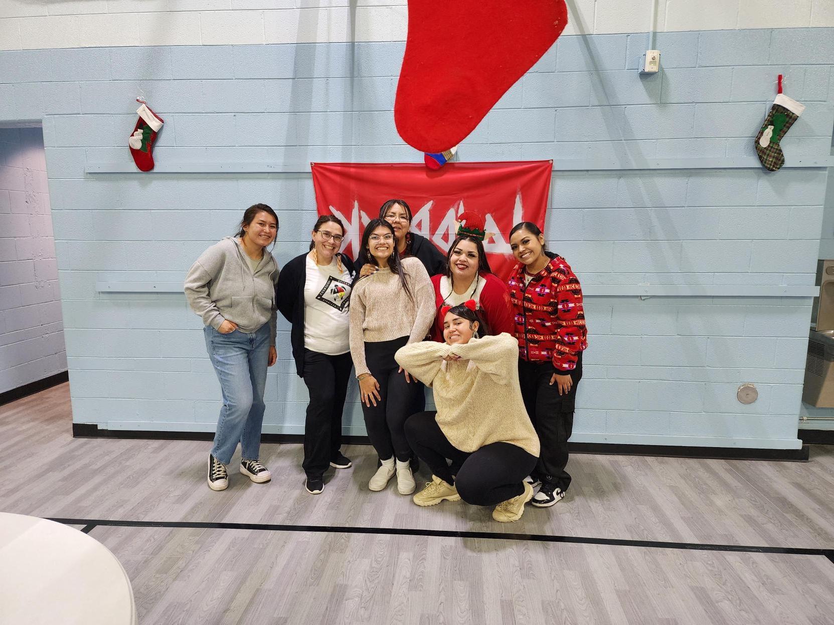 Group of students and community member pose in front of a 